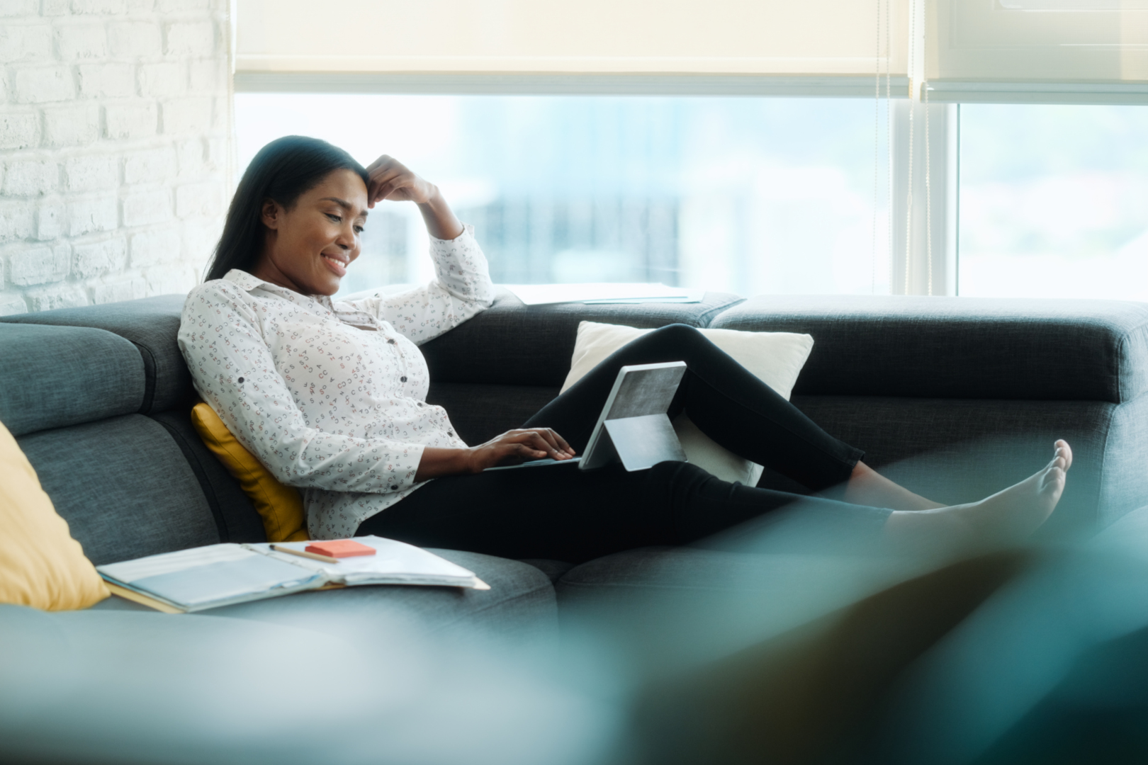 woman working from home using her laptop on the couch.jpg