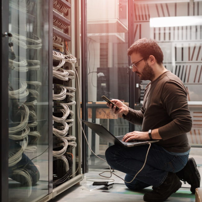 IT technician sysadmin at server checking network infrastructure