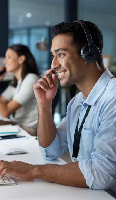 it tech support man wearing a phone headset troubleshooting 