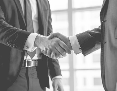Close-up image of 2 business people shaking hands